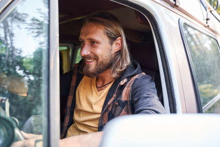 Man looking away while riding at the car