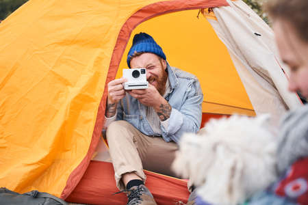 Man taking pictures on the instant camera