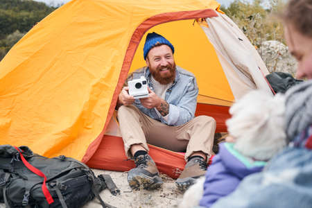 Man smiling and taking pictures