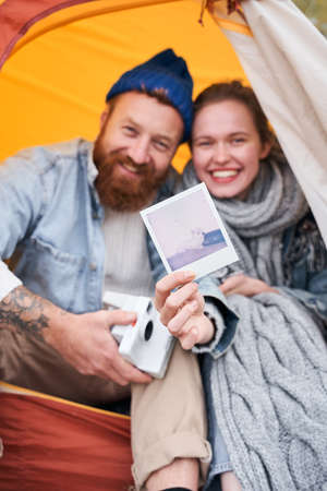 Couple showing photo of their dog