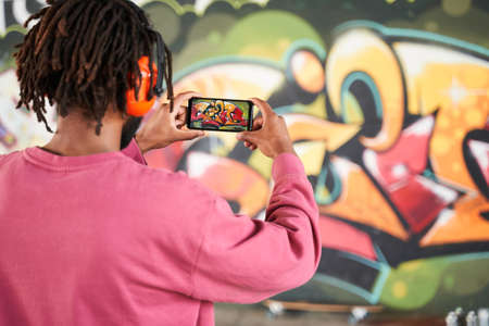 Guy making photo of his own art objectの写真素材