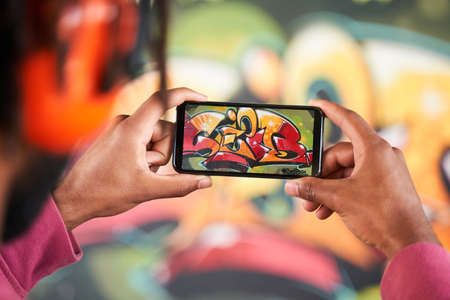 Man shooting his finished graffitiの写真素材