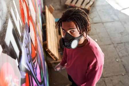 Street artist painting colored graffitiの写真素材