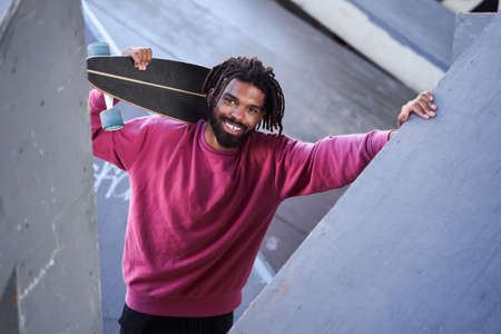 Man is carrying skateboard