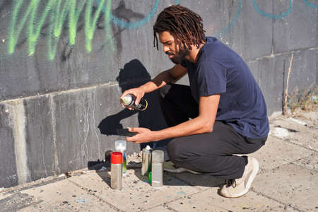 Man choosing spray canの写真素材