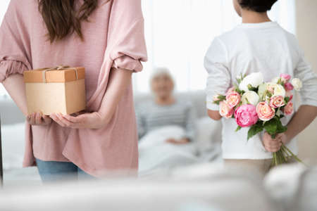 Grey-haired lady sitting in bed in the morningの写真素材