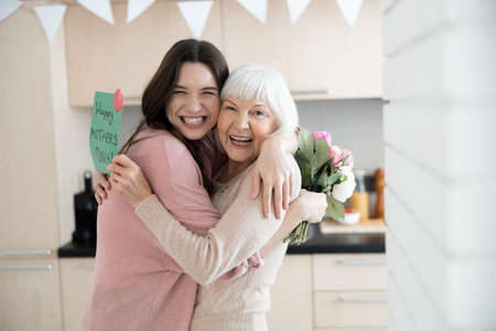 Happy women celebrating Mother Day at homeの写真素材