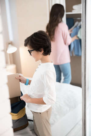 Male child putting a book into the bagの写真素材