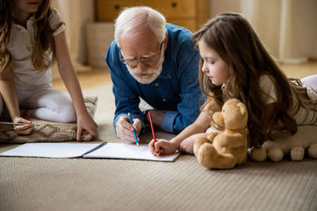 Family of three drawing in sketchbook stock photo