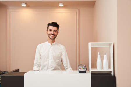 Hairdresser standing at the receptionの写真素材