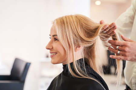 Woman discussing hairstyling with her hairdresserの写真素材