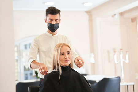 Man looking at his blonde clientの写真素材