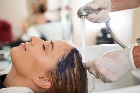 Hairdresser washing the clients hair