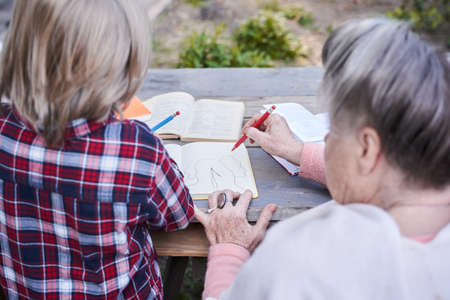 Family sitting at the wooden tableの写真素材