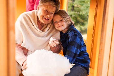 Grandmother and her grandson eating cotton candyの写真素材