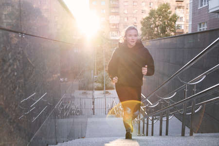 Girl running in the summer in the city