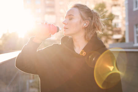 Woman greedily drinking waterの写真素材