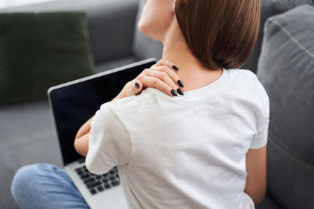 Stressed woman having a neck painの写真素材