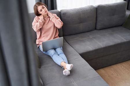 Woman touching stiff neckの写真素材