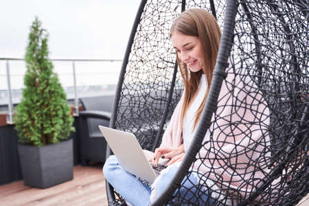 Woman sitting with her laptop copmputer