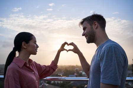 Couple showing heart symbol with the hands