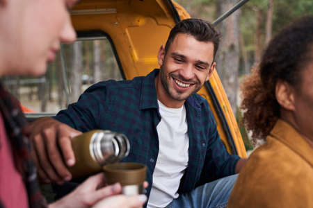 Man pours tea into a mugの写真素材