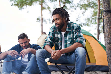 Guy roasted marshmallows over the fire