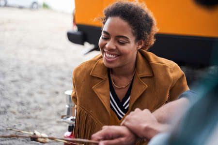 Girl camping and holding marshmallows