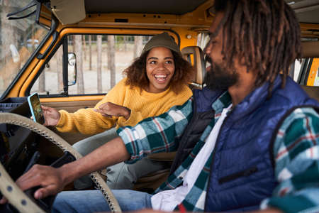 Man and woman chatting at the car