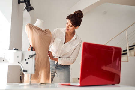 Woman is considering a version of a dressの写真素材