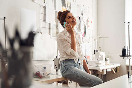 Designer using smartphone while sitting