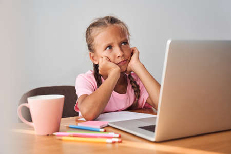 Girl is thinking with her head in her hands