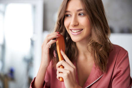 Woman combing her hair