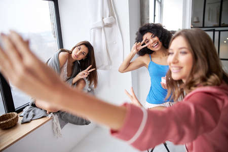 Girls gesturing while making selfieの写真素材