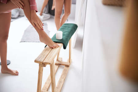 Girl using body creamの写真素材