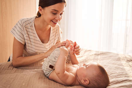 Woman playing and bonding with her newbornの写真素材