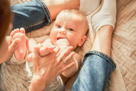 Boy shoves his fingers into his mouthの写真素材