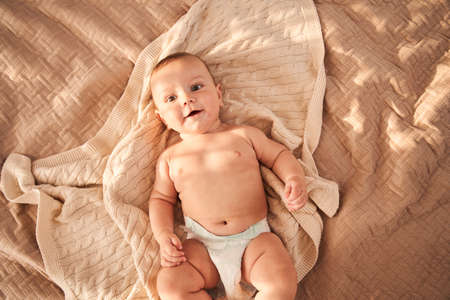 Newborn boy laying at the bedの写真素材