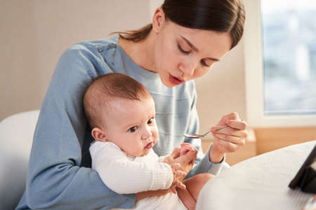 Woman holding her newborn babyの写真素材