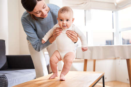 Baby taking first stepsの写真素材
