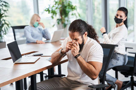 Man sitting and holding tissue napkinの写真素材