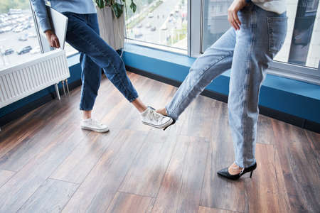 Women touch their feet togetherの写真素材