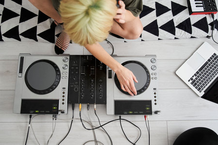 Female music producer sitting in her home studioの写真素材