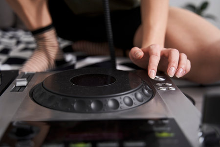 Songwriter sitting at the floor and touching dj consoleの写真素材