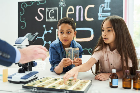 Inquisitive elementary school boy and girl studying beetle biology