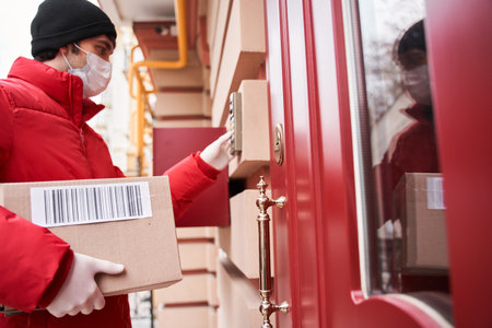 Courier deliver parcels in brown cardboard boxes to the doorの写真素材