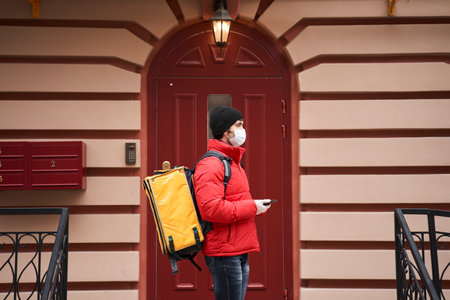 Courier guy checking order via mobile phone