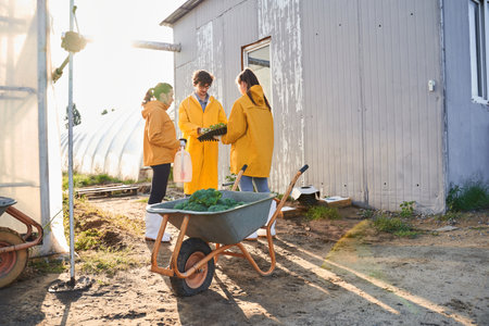 Team of young agronomists working on farmの写真素材