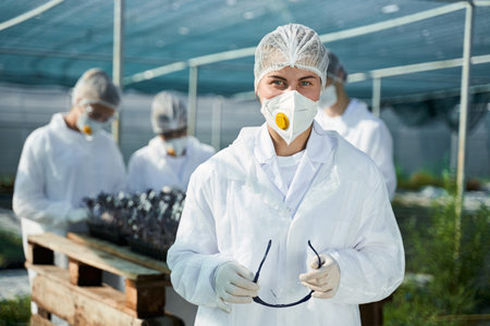 Happy female agronomist during working day in greenhouseの写真素材