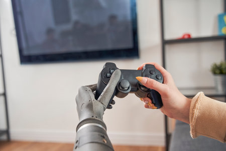 Woman with artificial limb playing video game with joystickの写真素材